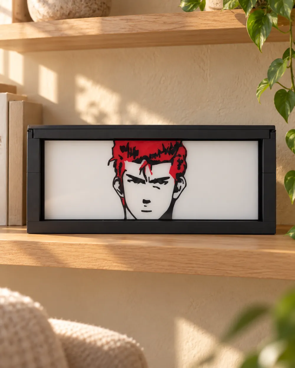Slam Dunk anime light box switched off on a wooden shelf in daylight